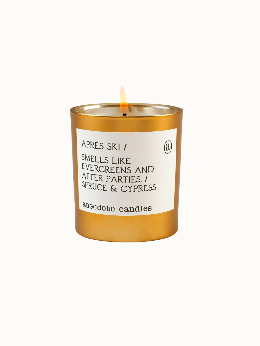 Anecdote Candles Aprés Ski Candle in gold tumbler with fragrance notes of spruce and cypress, a perfect holiday gift
