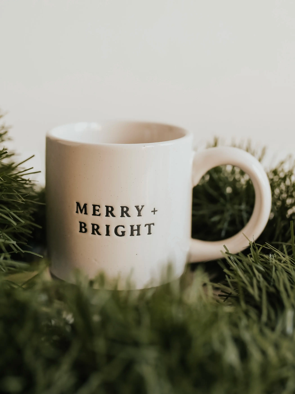 14 oz stoneware mug with Merry and Bright in black letters. 